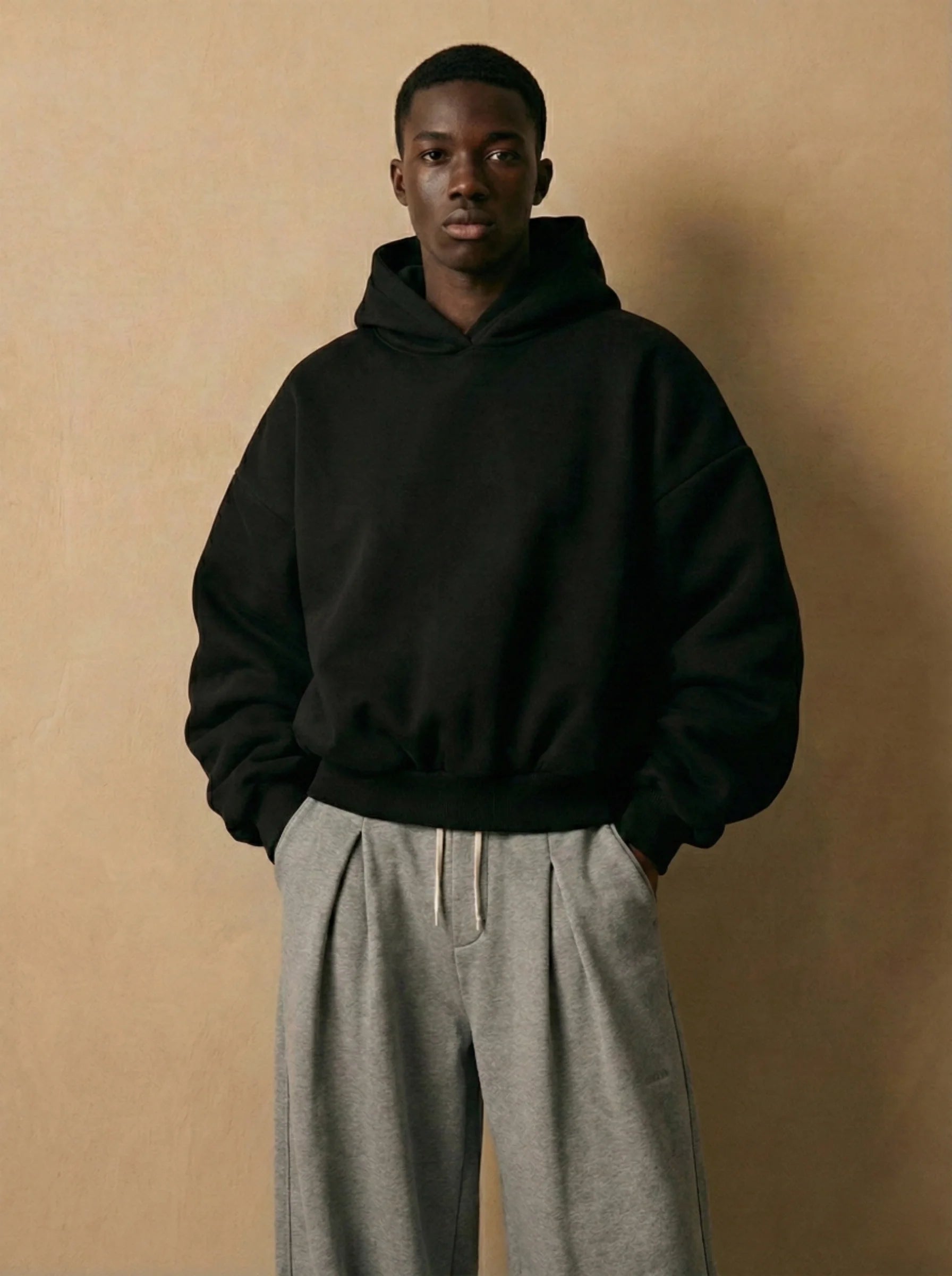 Oversized Cotton Hoodie Olive Render Worn by a Male model in sitting pose.