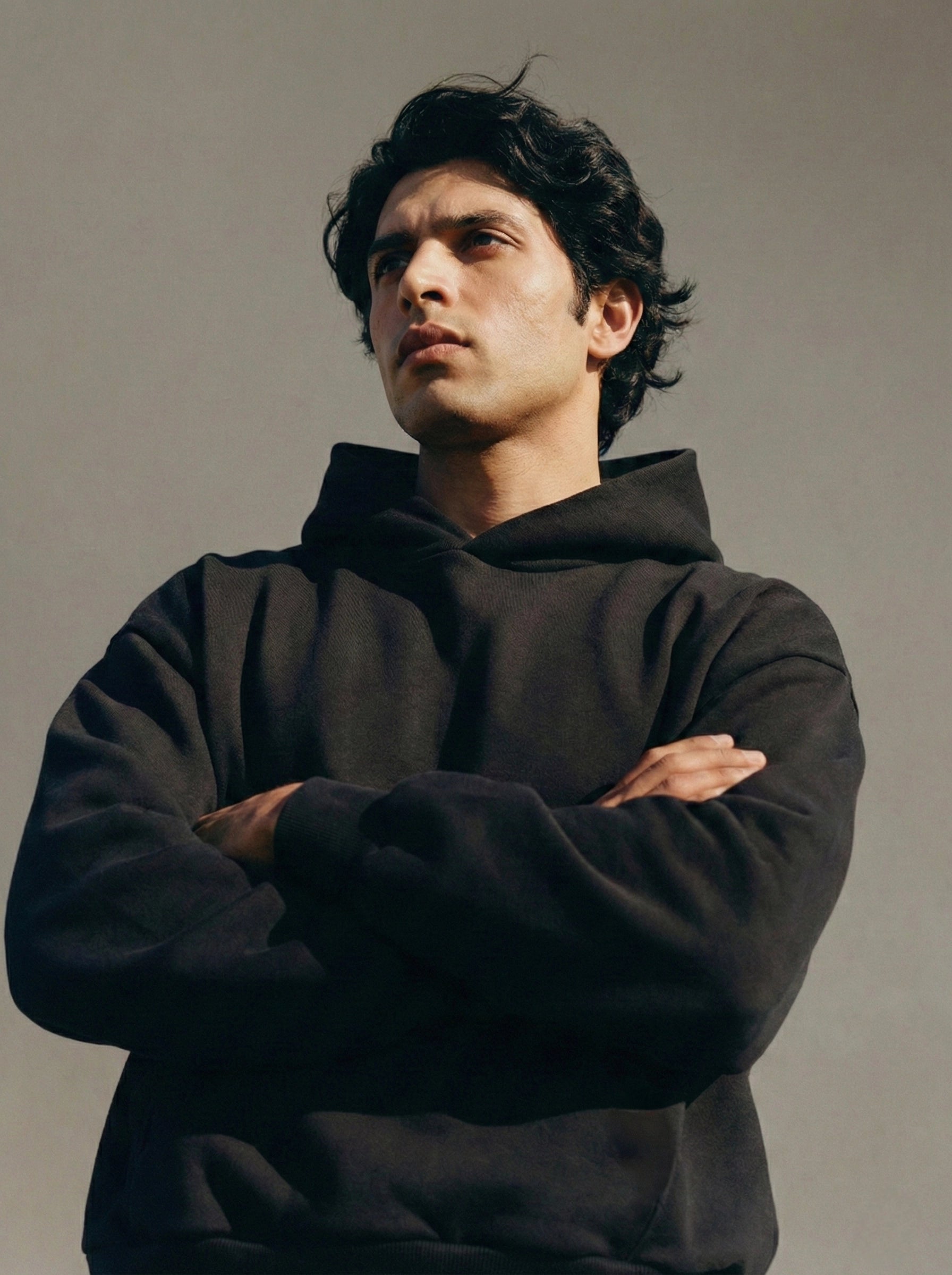 Man wearing a black hoodie against a plain background